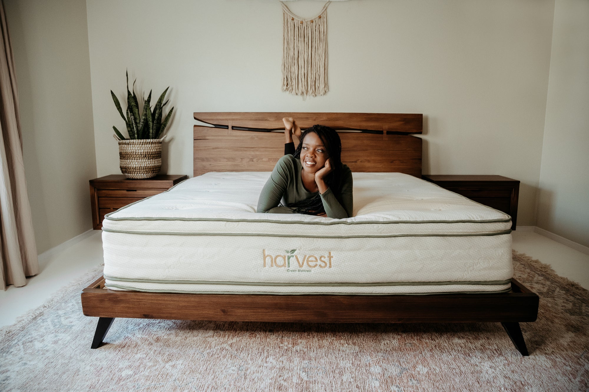 Model Laying On The Edge Of Her Harvest Green Mattress