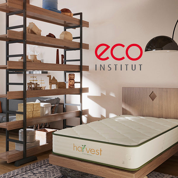 Room image of our harvest green essentials mattress with the eco-INSTITUT certification logo