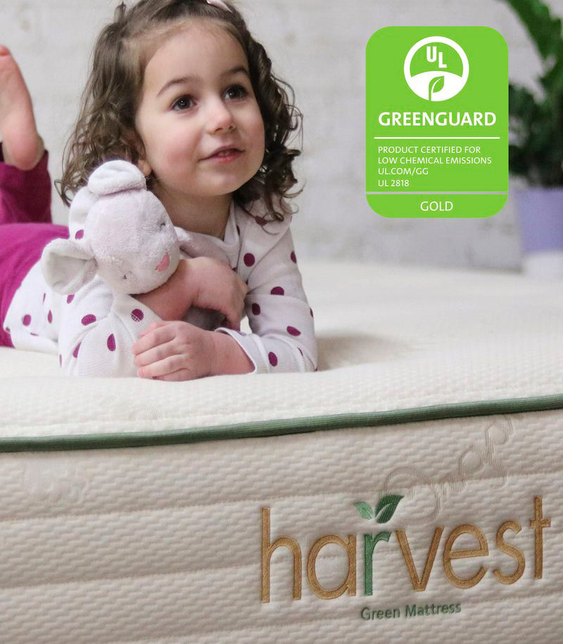 Greenguard gold logo Image of a little girl holding a teddy bear on our Harvest green original mattress.