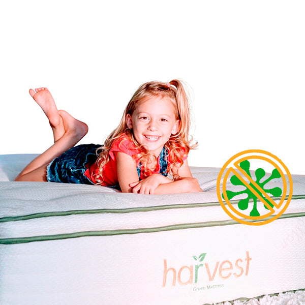 Little girl laying on our pillow top mattress with our Anti-Bacterial Logo