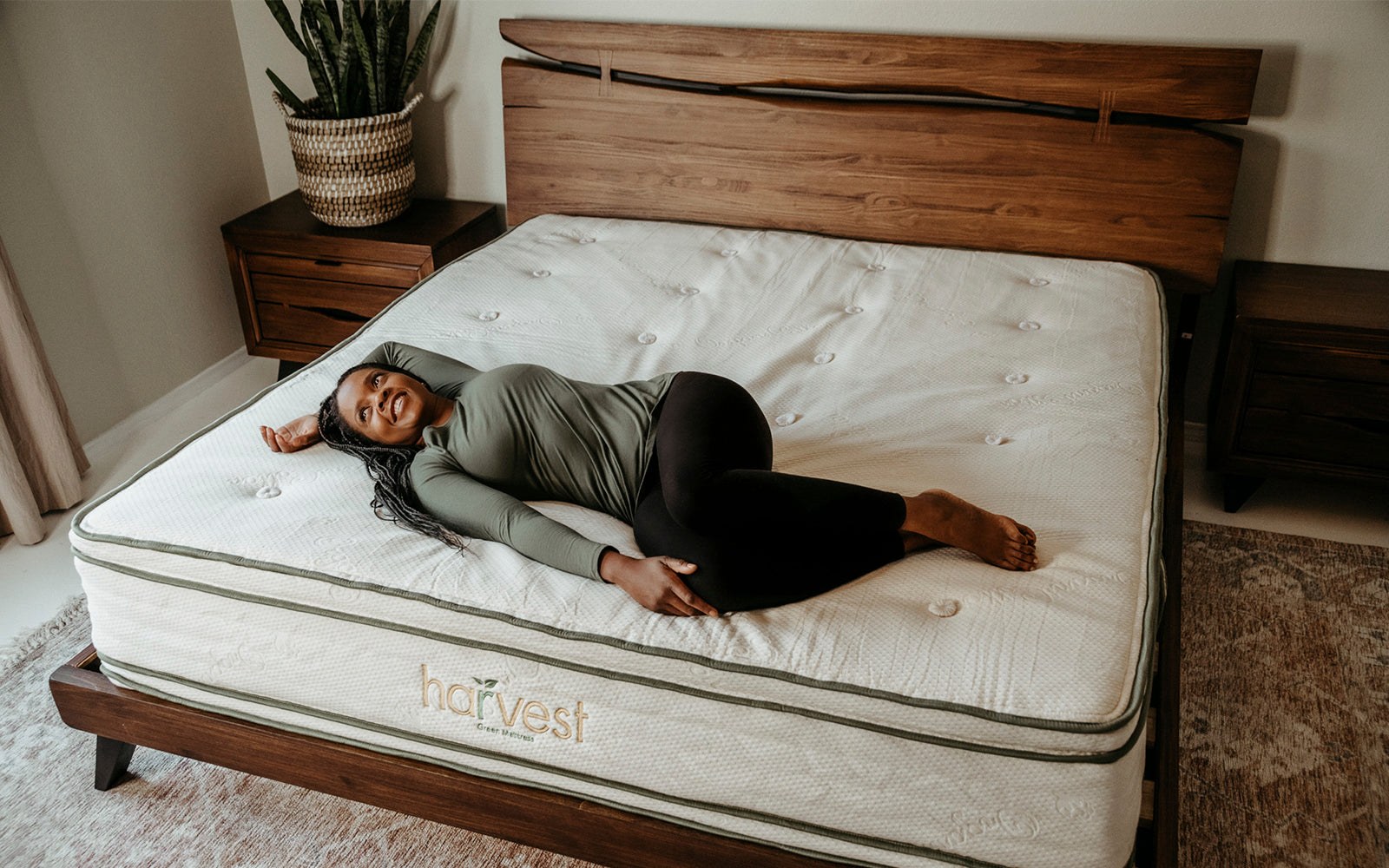 Why Buy A Harvest Green Mattress?  Lady laying on Harvest Double Sided Pillow Top